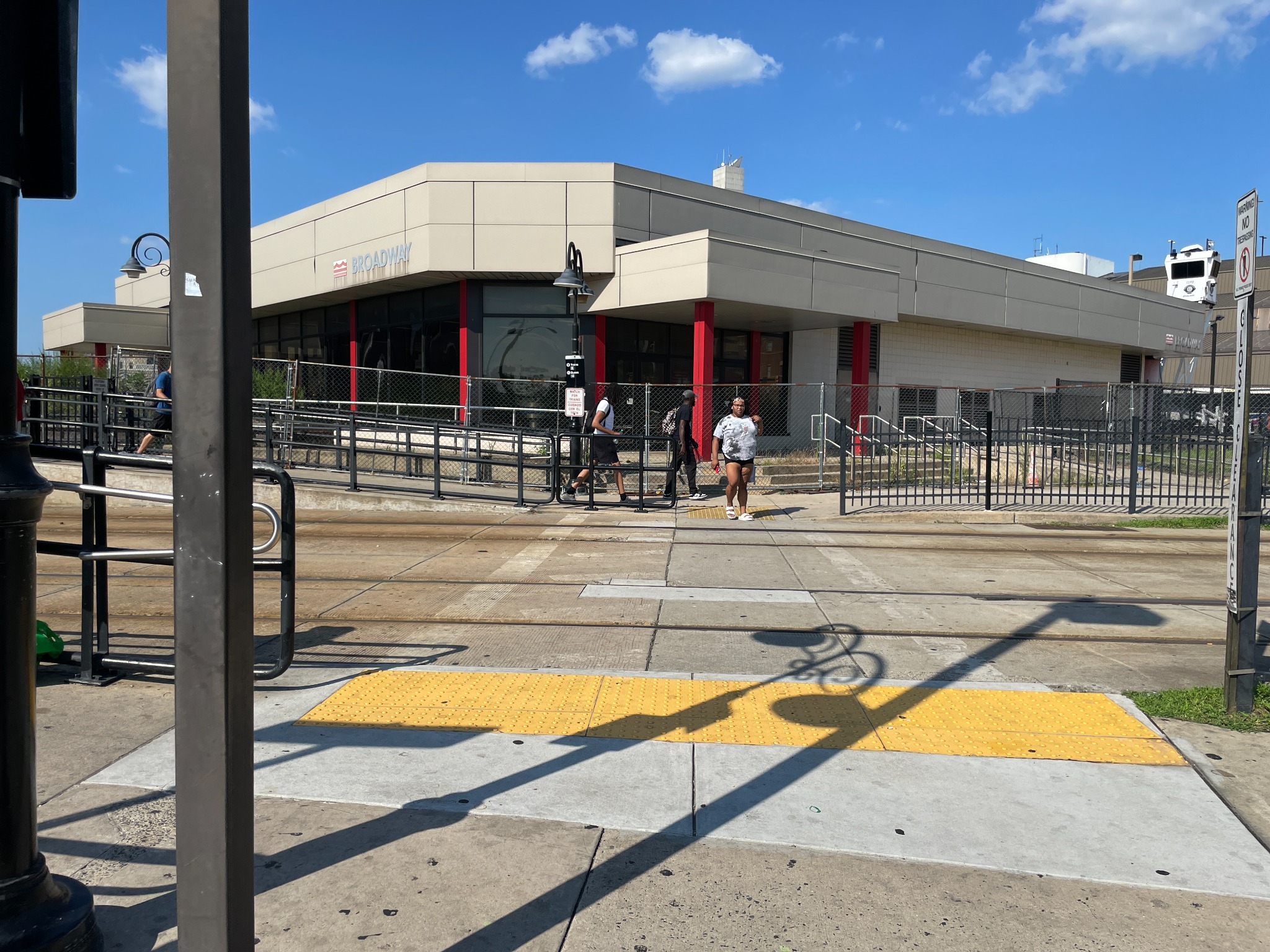 Pedestrians near a transit station crossing embedded rails